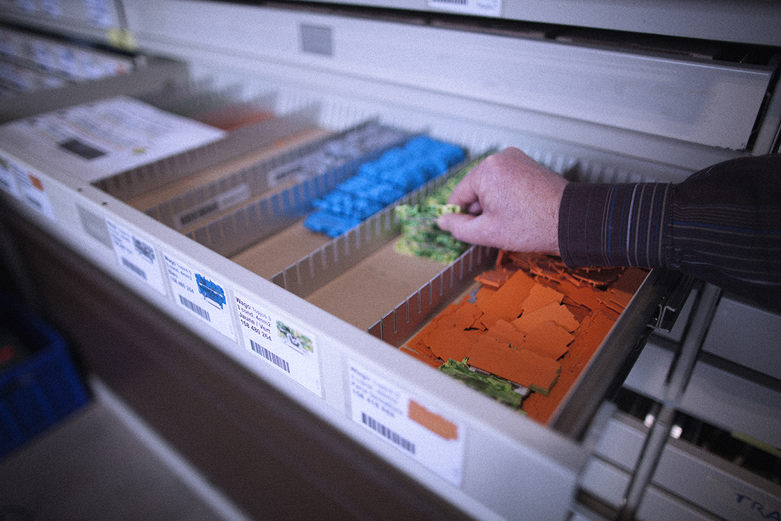 Un électricien sélectionne une borne WAGO dans le tiroir du stock d'électricité Progin SA